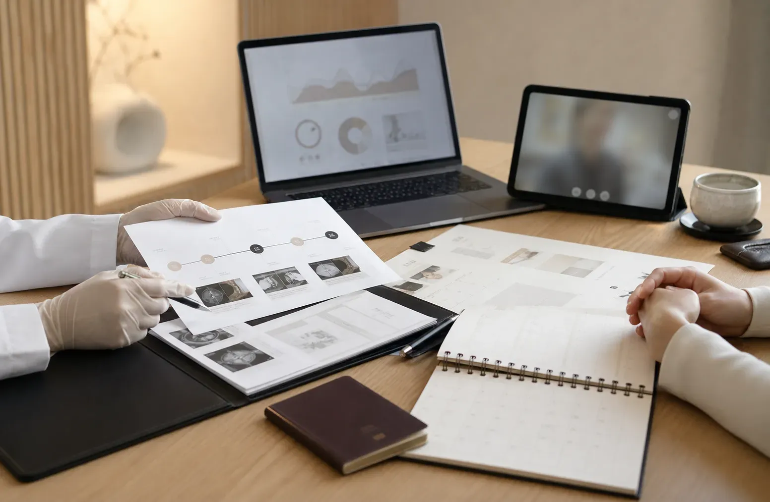 A physician-led planning session with medical records, travel documents, and a remote consultation screen